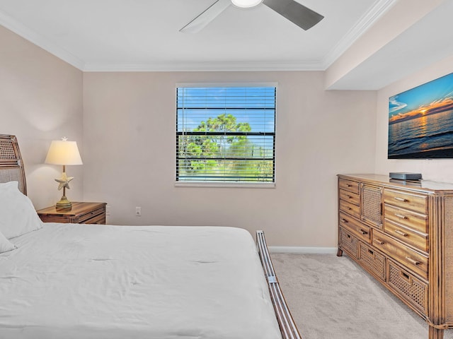 carpeted bedroom featuring crown molding and ceiling fan