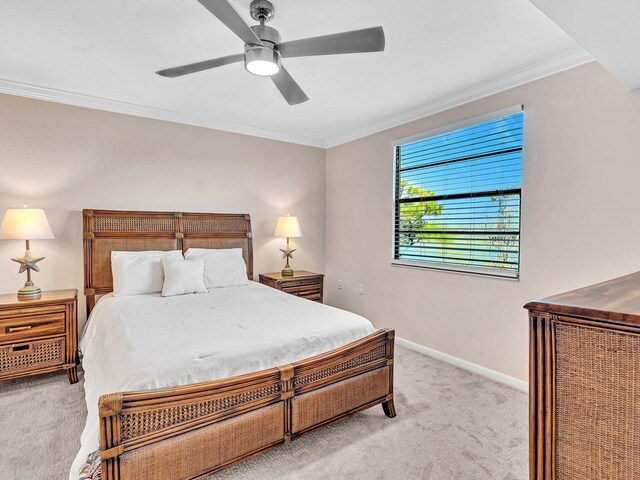 bedroom with ceiling fan, light colored carpet, and ornamental molding