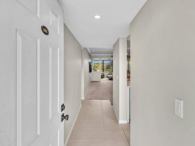 hallway featuring light colored carpet