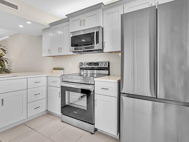 kitchen featuring light tile patterned floors and stainless steel appliances