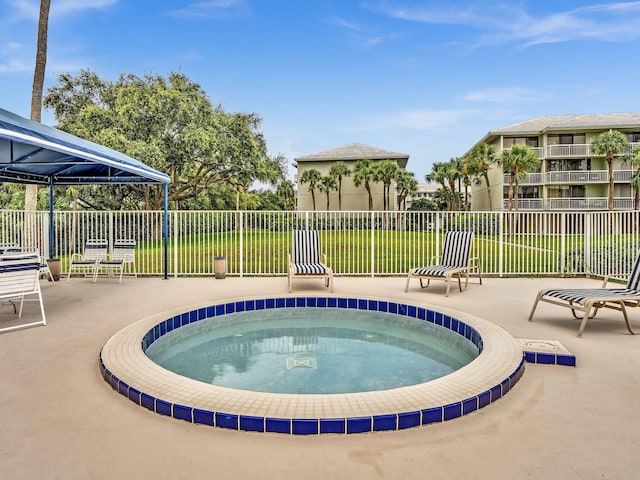 view of pool with a hot tub and a gazebo