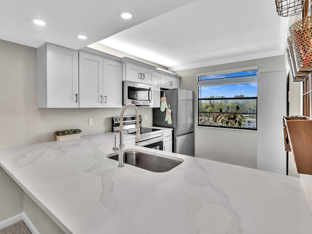 kitchen featuring sink, light stone counters, white cabinetry, crown molding, and stainless steel appliances