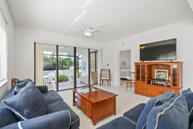 living room featuring light wood-type flooring and ceiling fan