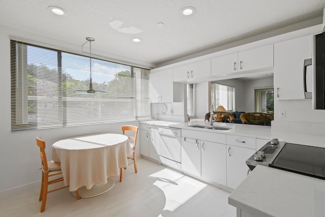 kitchen featuring plenty of natural light, sink, and white cabinets