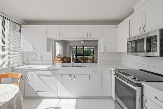 kitchen featuring sink, appliances with stainless steel finishes, and white cabinets