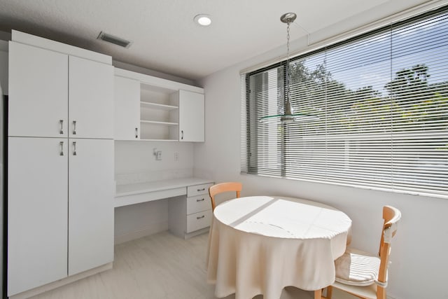 dining area with light tile patterned floors and built in desk