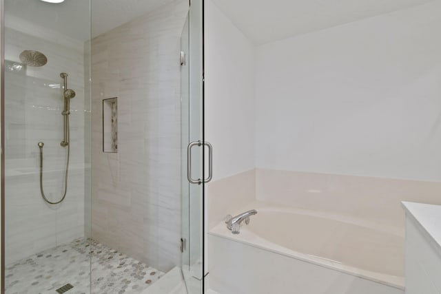 bathroom with separate shower and tub