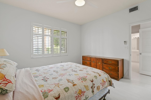 bedroom with ensuite bath and ceiling fan