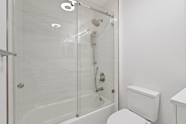 full bathroom featuring bath / shower combo with glass door, toilet, and vanity