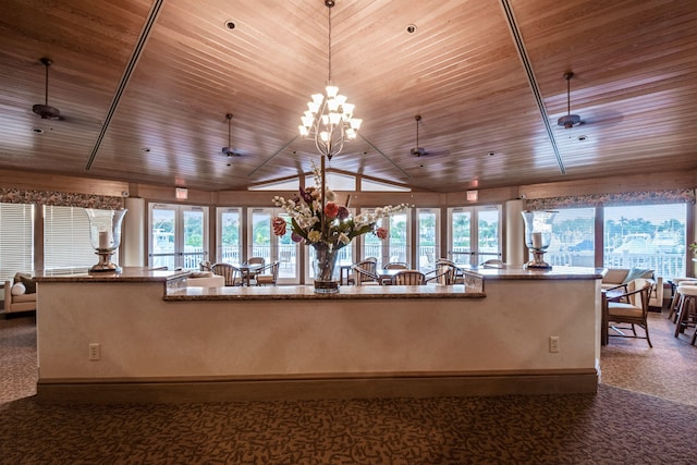 kitchen with plenty of natural light, dark carpet, wooden ceiling, and lofted ceiling