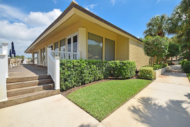 view of side of home featuring a wooden deck