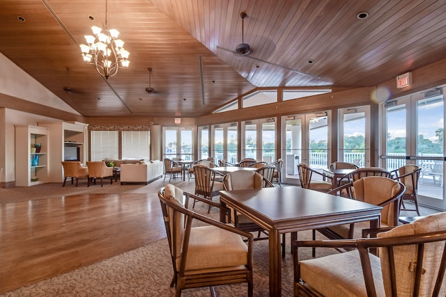 dining area featuring a notable chandelier, carpet floors, lofted ceiling, and wood ceiling