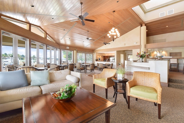 carpeted living room with a skylight, wooden ceiling, ceiling fan with notable chandelier, and high vaulted ceiling