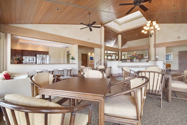 carpeted dining space featuring a skylight, ceiling fan with notable chandelier, high vaulted ceiling, and wooden ceiling