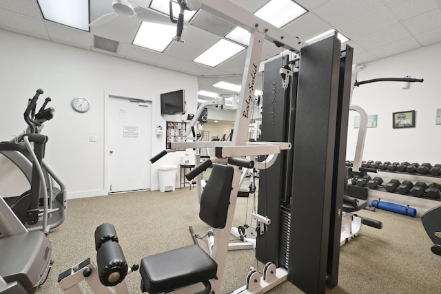 exercise room with carpet flooring and a paneled ceiling