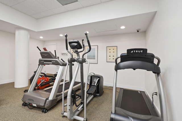 exercise room with carpet floors and a drop ceiling