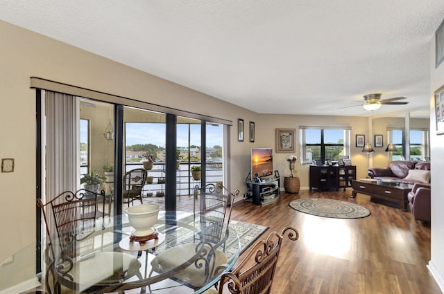 dining area featuring hardwood / wood-style flooring, a textured ceiling, french doors, and ceiling fan