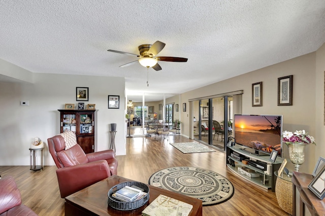 living room featuring a textured ceiling, ceiling fan, and hardwood / wood-style floors