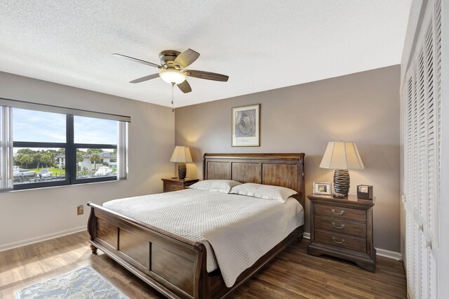 bedroom featuring a closet, ceiling fan, and dark hardwood / wood-style floors