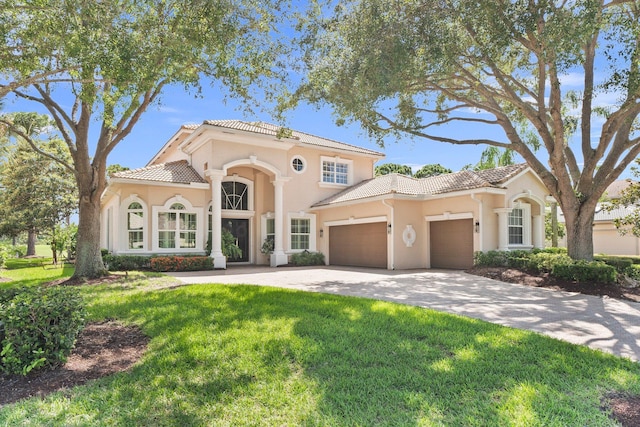 mediterranean / spanish-style home with a front lawn and a garage