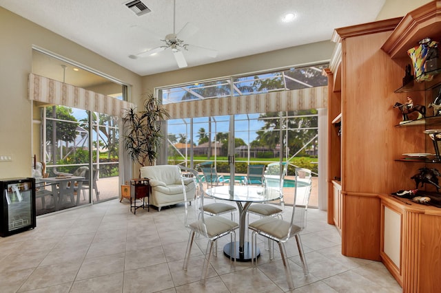 sunroom with wine cooler and ceiling fan