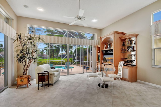 sitting room with ceiling fan and plenty of natural light