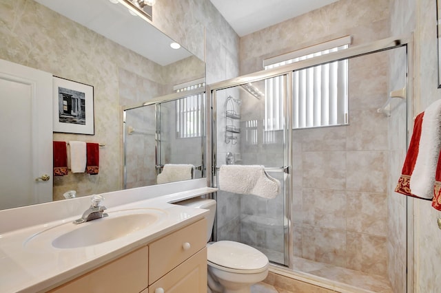 bathroom with vanity, toilet, and a shower with shower door