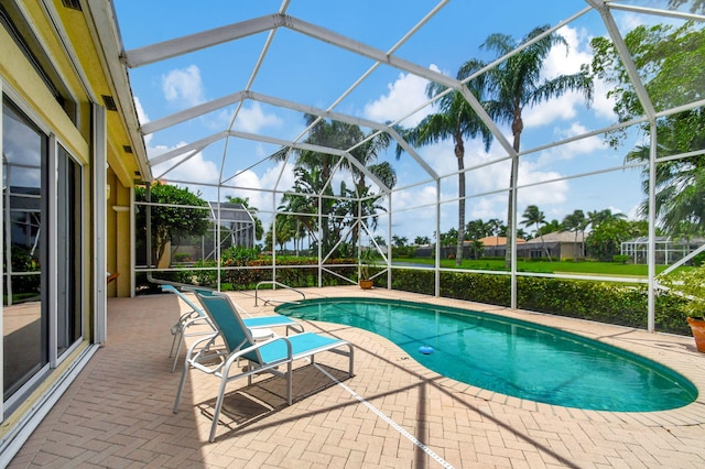 view of pool with a lanai and a patio