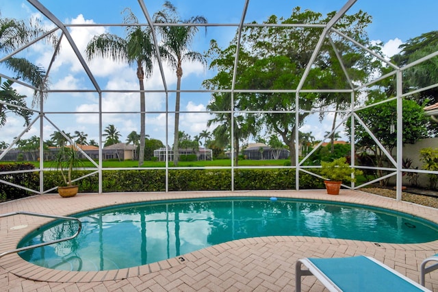 view of swimming pool featuring a lanai and a patio area