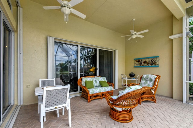 view of patio featuring an outdoor living space, a lanai, and ceiling fan