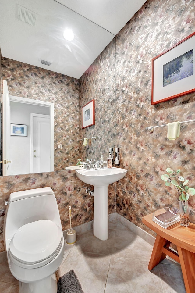 bathroom with tile patterned floors and toilet