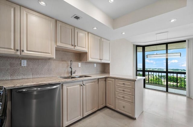 kitchen featuring a sink, visible vents, stainless steel dishwasher, decorative backsplash, and a wall of windows