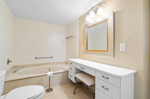 bathroom featuring a garden tub, vanity, and toilet