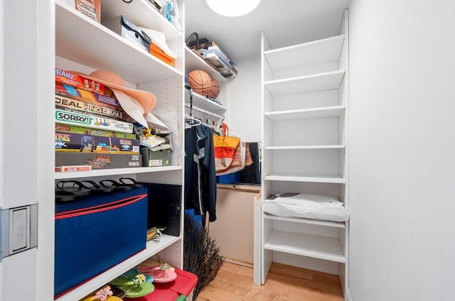 spacious closet featuring light wood-style flooring