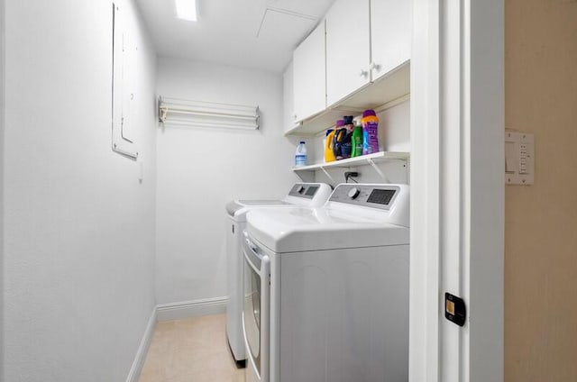 laundry area featuring cabinet space, independent washer and dryer, and baseboards