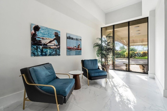 living area with marble finish floor and baseboards