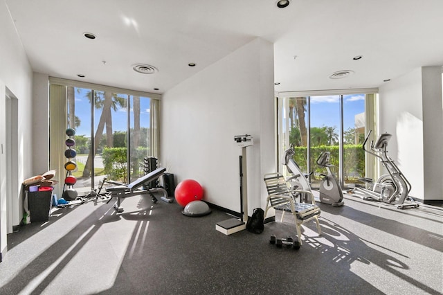 workout area featuring visible vents and floor to ceiling windows