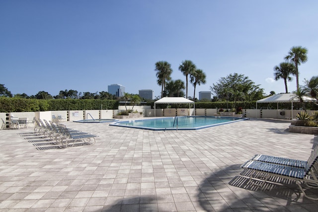 pool featuring a patio area and fence