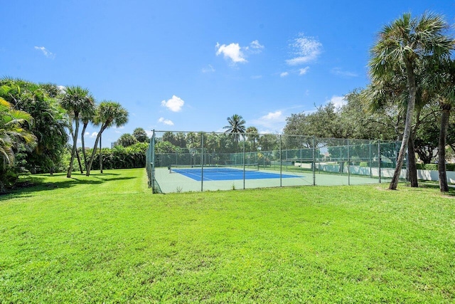 view of sport court featuring a lawn and fence