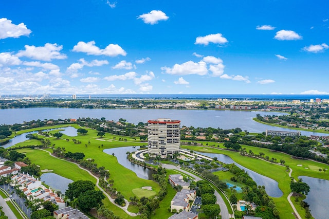 birds eye view of property with a water view and golf course view