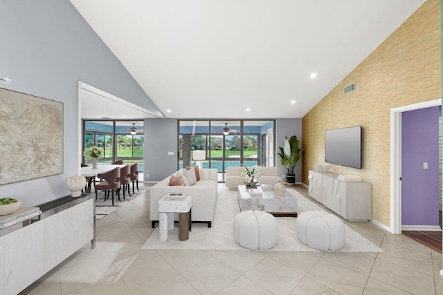 living area with a healthy amount of sunlight, light tile patterned floors, and a ceiling fan