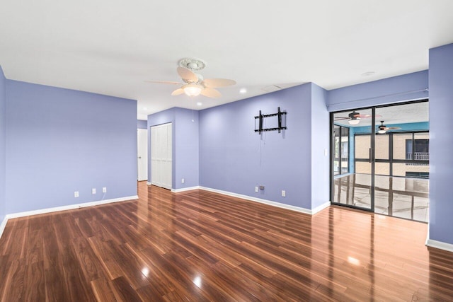 unfurnished room with a ceiling fan, dark wood-style flooring, and baseboards