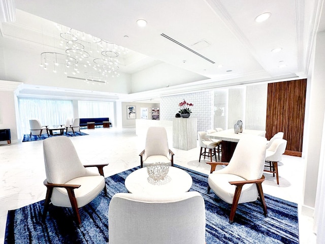 sitting room featuring marble finish floor, recessed lighting, a raised ceiling, ornamental molding, and a chandelier