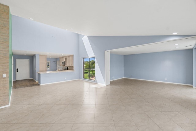 unfurnished living room with light tile patterned floors, baseboards, high vaulted ceiling, and recessed lighting