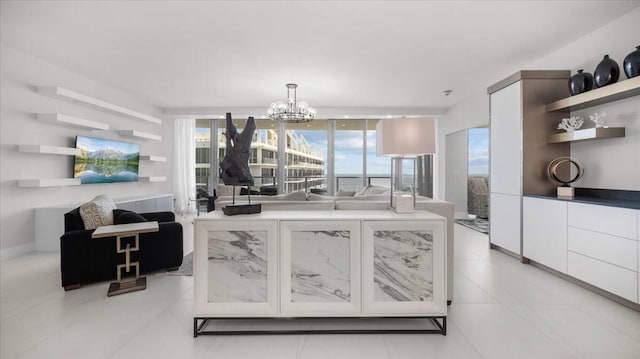 kitchen with decorative light fixtures, light tile patterned flooring, white cabinetry, and a chandelier