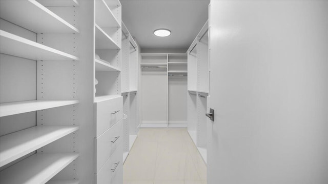 spacious closet with light tile patterned floors