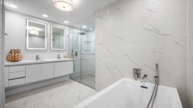 bathroom with vanity and separate shower and tub