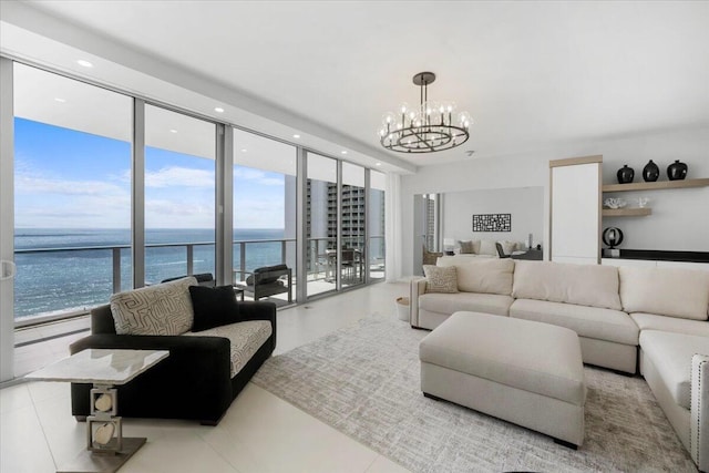 tiled living room with a water view, expansive windows, and a notable chandelier