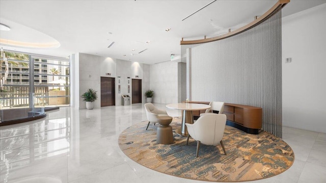 dining room featuring floor to ceiling windows and elevator