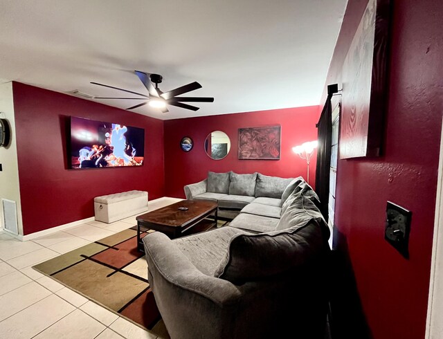 living room featuring light tile patterned flooring and ceiling fan